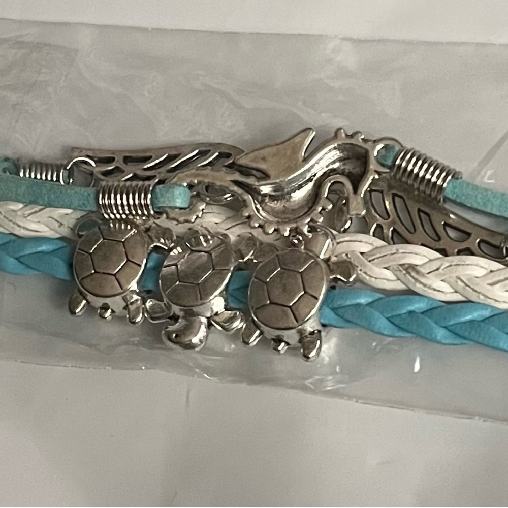 Brand New in Package corded bracelet cute charms. Each one come with happies